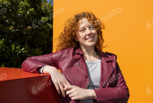 Preview: Natural smiling redhead woman posing in bright city light