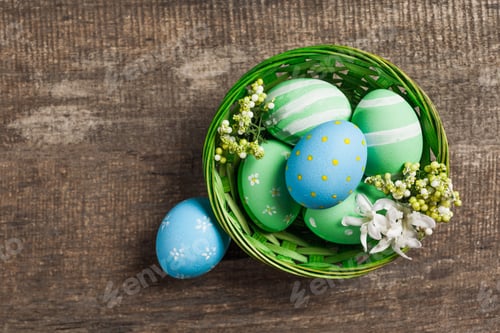 Preview: Easter eggs in nest on color wooden background