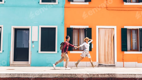 Preview: Couple of happy tourists visiting Burano, Italy -