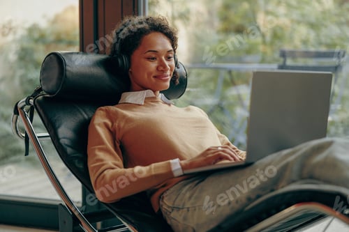 Preview: Happy business woman working remotely on laptop from home. Distance work concept