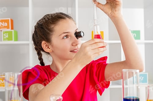 Preview: Girl studying chemistry in laboratory