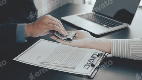 Preview: Businessman hand holding dollar bank note money to bribe financial officials