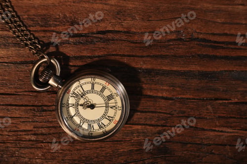 Preview: Pocket clock with chain on wooden table, top view. Space for text
