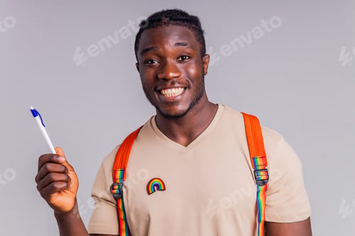 Preview: hispanic student man with rainbow badge on t-shirt in studio isolate