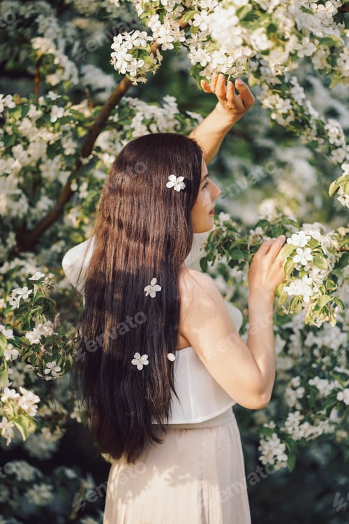 Preview: beautiful girl near a blooming apple tree