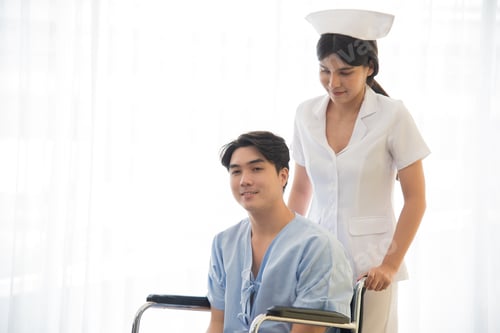 Vista previa: Asian nurse in working uniform taking care of patient sitting on wheel chair.