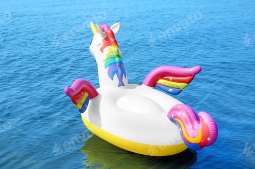Preview: Funny inflatable unicorn ring floating on sea water. Summer vacation
