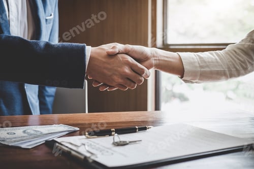 Preview: Real estate agent and customers shaking hands together celebrating finished contract after about