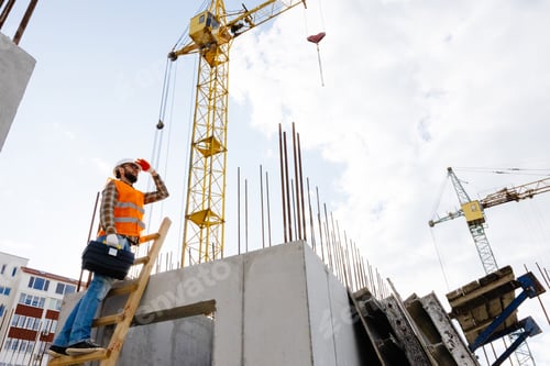 Preview: Maintenance worker man with safety helmet climbing wood step ladder and holding toolbox