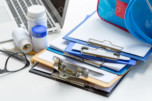 Preview: Stethoscope lying on medical form on clipboard .