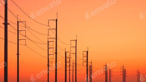 Preview: Silhouette rows of electric poles with cable lines against colorful orange sunset sky background
