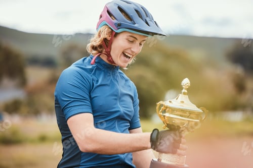 Preview: Winner, trophy and achievement with a woman cyclist in celebration of victory outdoor after a race.