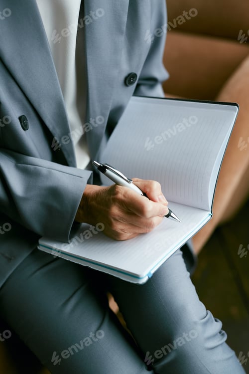 Preview: Successful Businesswoman Writing in Planner
