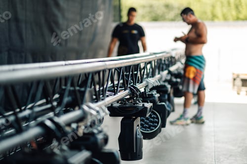 Preview: Lighting technicians preparing spotlights for a live event