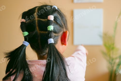 Preview: Adorable Child's Ponytails with Colorful Accessories Indoors