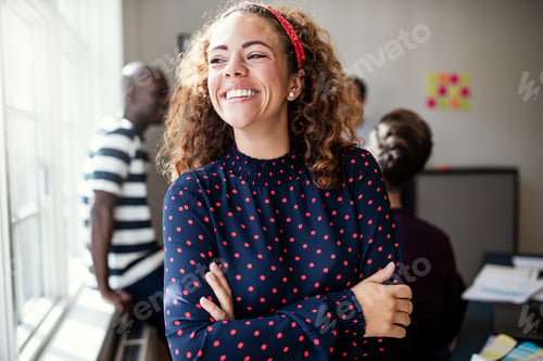 Vista previa: Laughing young designer standing in an office after a meeting