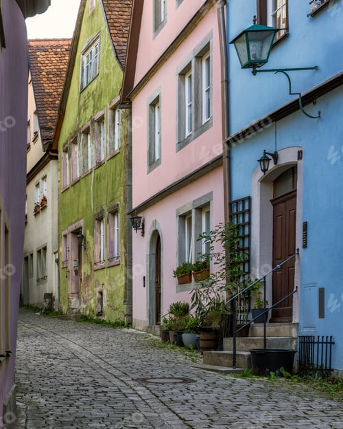 Preview: Colorful buildings line a narrow cobblestone street