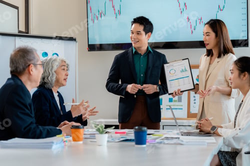 Preview: Asian businesspeople discussing during a meeting in the office