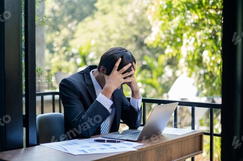 Preview: Working Asian men feel stressed, tired from work, migraine headaches from hard work while working