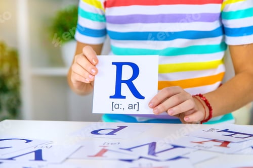 Preview: The child learns English letters. Selective focus.