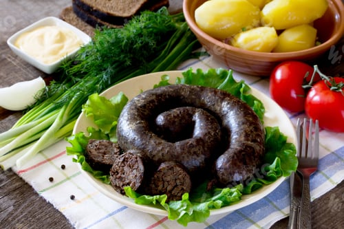 Preview: Homemade buckwheat liverwurst and sausage and boiled potatoes on a rustic background.