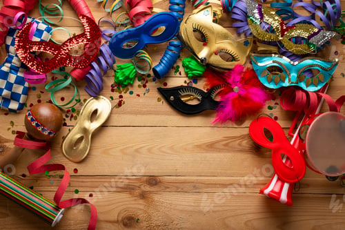 Preview: Carnival background on a wooden surface. Masks, coiled streamers, confetti and many more