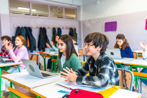 Preview: Students raising hands and interacting during class at school