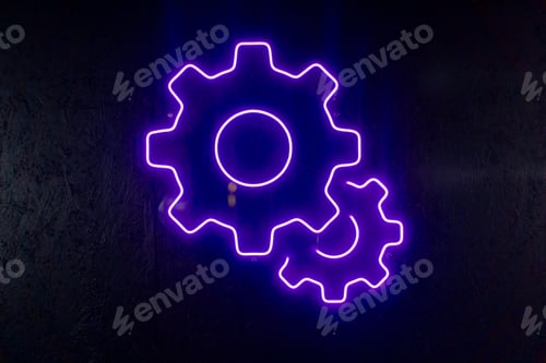 Preview: close-up At service station neon sign in the shape of a gear for oil hangs on the wall purple light