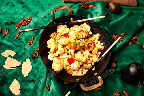 Preview: Stir-fried Cauliflower Delight in a Wok, Oriental Spices on a Green Velvet