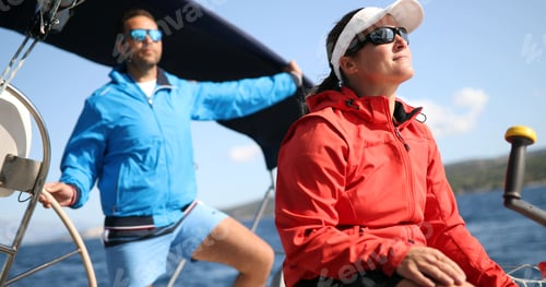 Preview: Young strong beautiful woman sailing the boat