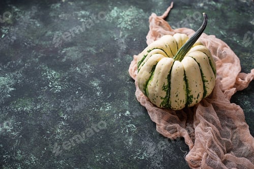 Preview: Decorative pumpkin on green concrete background