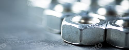 Preview: Working tool. Metal nuts on the table.