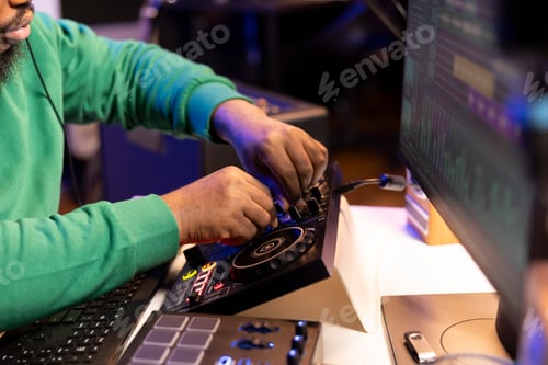 Preview: Audio engineer producing new music on mixing console in home studio