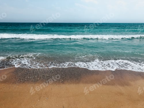 Preview: Sea blue aquamarine waves line sunny sand beach. Soft wave of ocean foam.