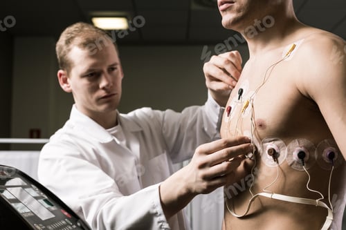 Preview: Doctor putting the cardiogram electrodes