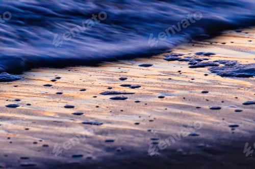 Preview: a close up of the edge of a sand covered beach