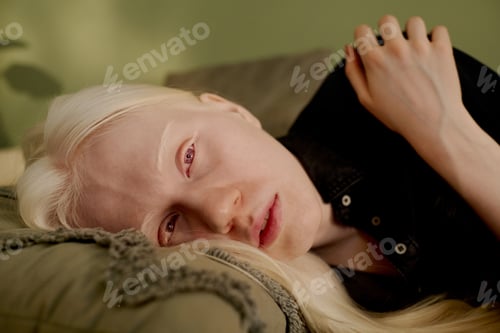 Preview: Young Woman With White Hair Lying On Sofa