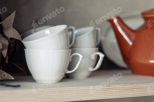 Preview: white cups on the shelf close-up