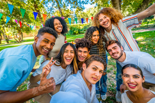 Preview: Multi-ethnic students taking selfie celebrating party in a park