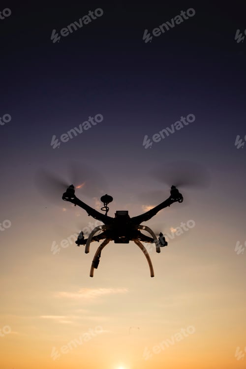 Preview: Quadrocopter in flight at sunset