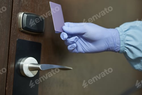 Preview: Man in protective clothing opening the door to the room