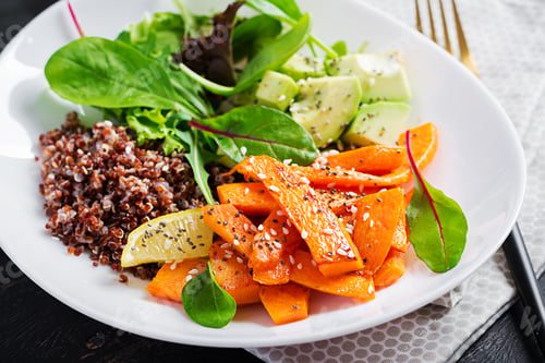 Preview: Buddha bowl with quinoa, fried sliced pumpkin, avocado and green herbs.