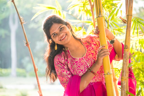 Preview: Happy smiling girl in bamboo forest.
