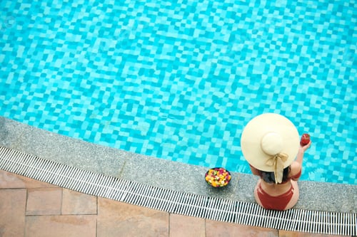 Preview: Woman In Hat Sitting Near Pool