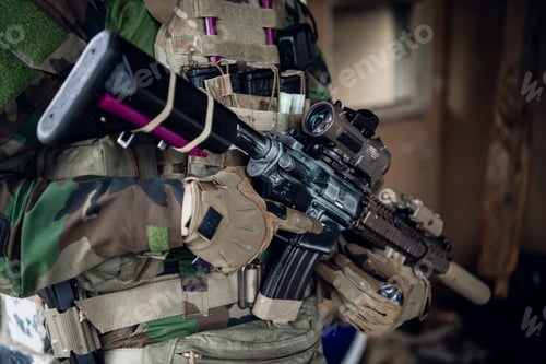 Preview: Weapons close-up on a military man standing inside the building and waiting for command
