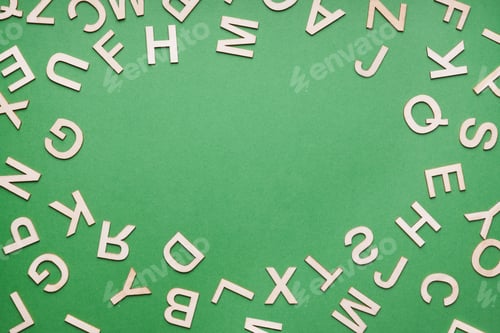 Preview: random wooden letter frame on green paper background
