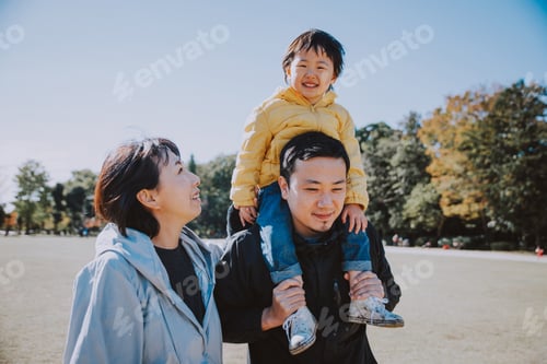 Preview: Happy japanese family spending time outdoor