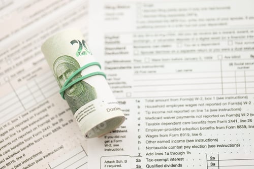 Preview: Mexican pesos money bills in big amount lies on table with tax forms close up