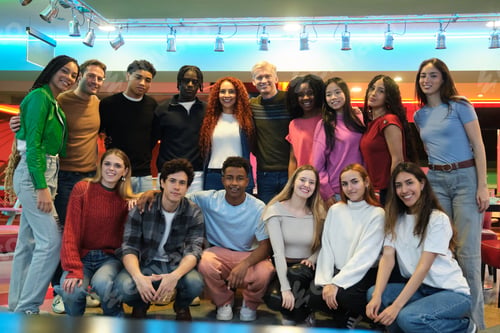 Preview: Diverse group of young students posing together in a bowling alley