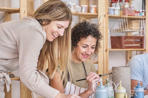 Preview: Joyful women painting ceramics in a workshop